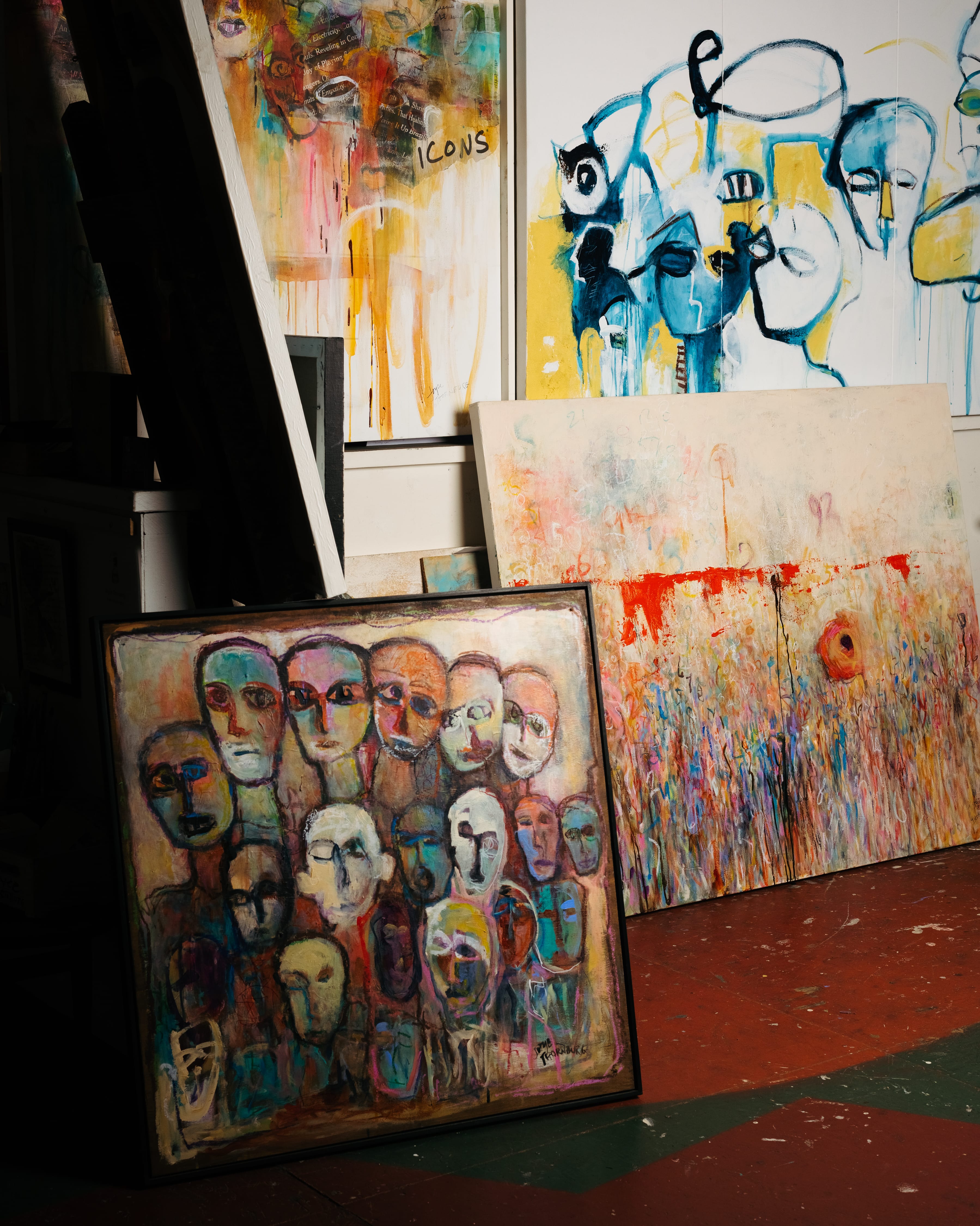 Paintings leaning against walls in a studio