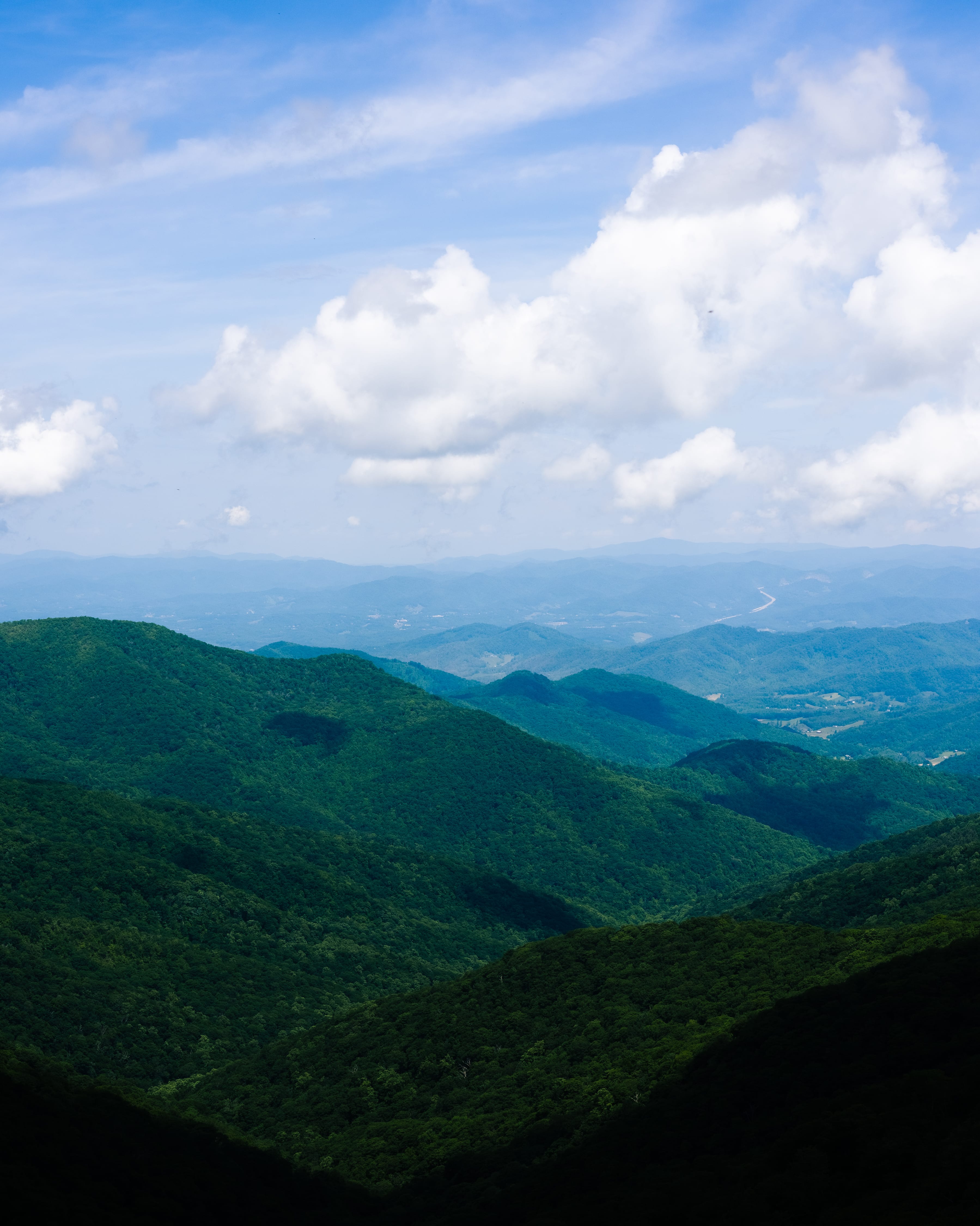 A blue-toned scenic look over green mountains