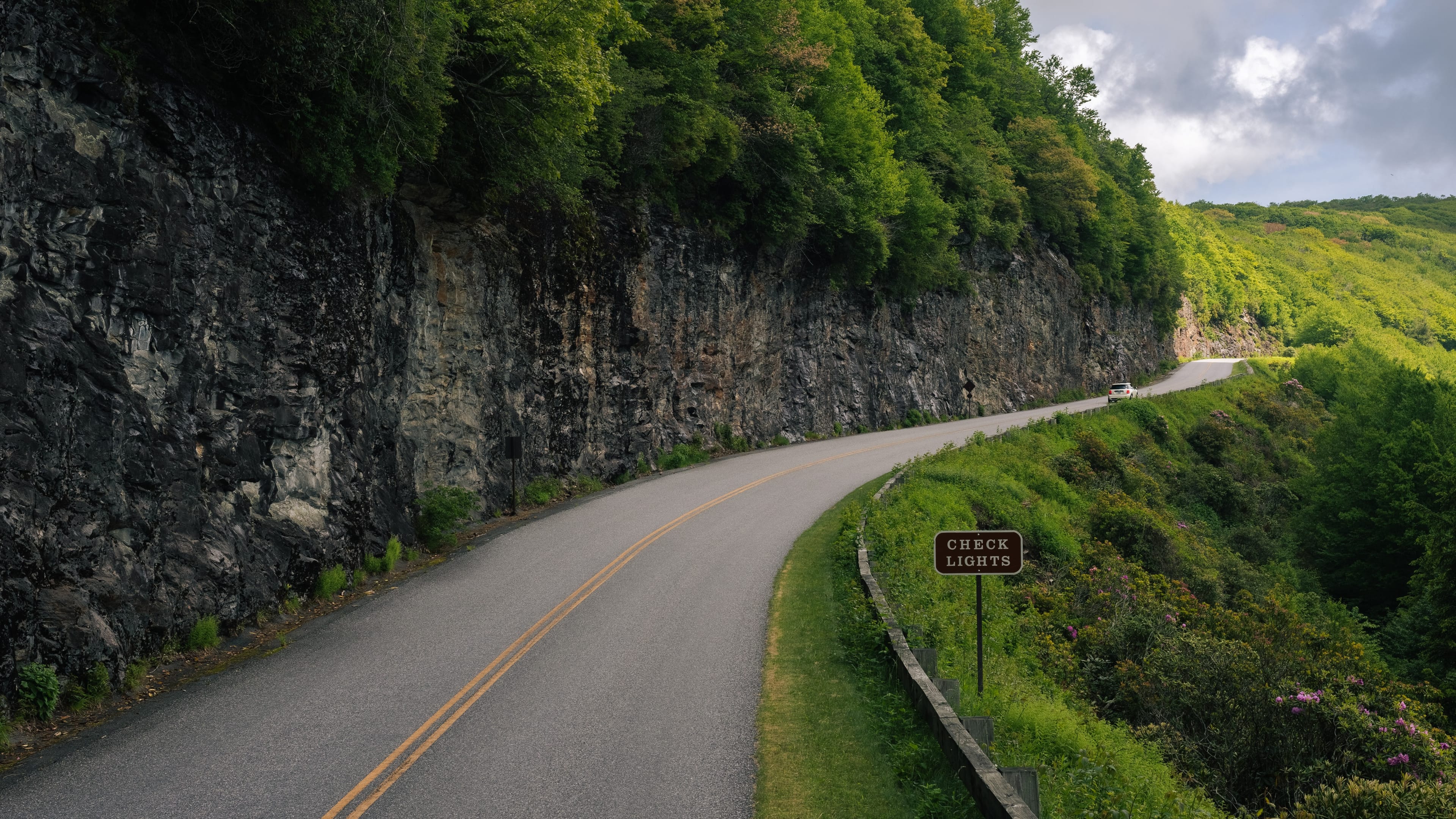 A curving road through lush landscape