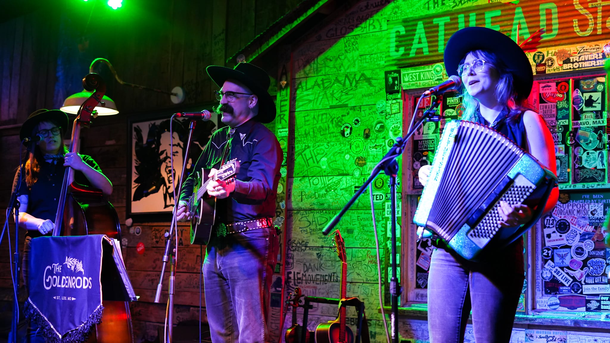 Three musicians perform on stage in Tupelo, Mississippi.